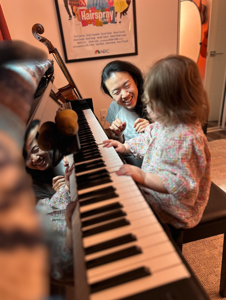 Day teaching a young child at the piano